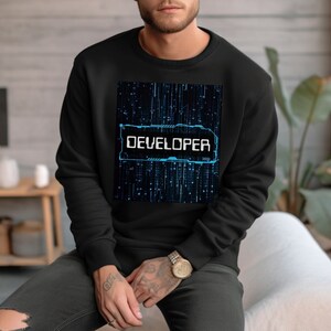 May include: Black sweatshirt with a blue and white graphic design that says "DEVELOPER" on a black background.