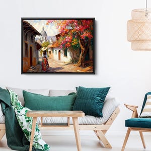 May include: A painting of a woman walking down a street in a small town. The street is lined with colorful buildings and there are trees with pink flowers in bloom. The woman is wearing a long dress and a hat.