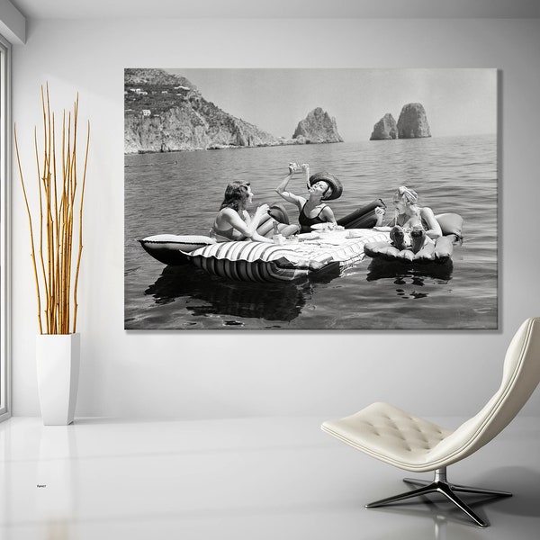 Women Eating Pasta on Lake, Floating Luncheon Canvas Print | Three young women eat spaghetti on inflatable mattresses at Lake of Capri 1939