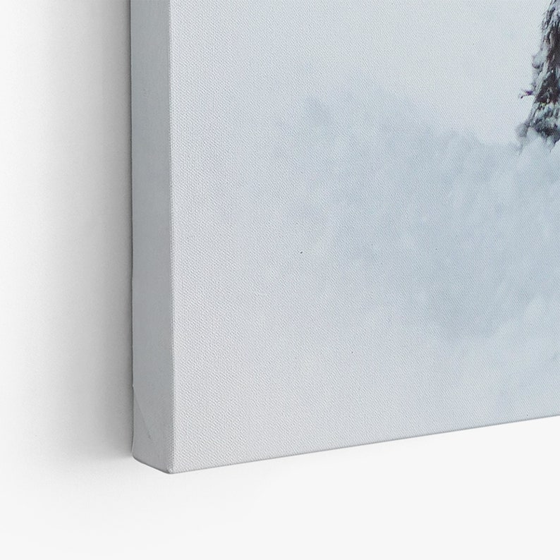 May include: A close-up of a white canvas painting with a single dark green tree in the upper right corner. The tree is partially obscured by a white fog or mist.