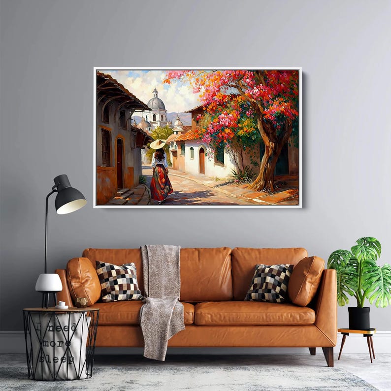 May include: A painting of a woman in a red dress and a straw hat walking down a street in a small town. The street is lined with white buildings and there are trees with pink flowers in bloom.