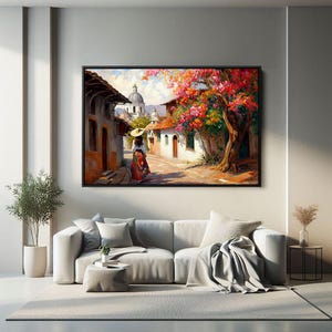 May include: A painting of a woman in a straw hat walking down a cobblestone street lined with colorful buildings. The street is shaded by a large tree with pink and red flowers.