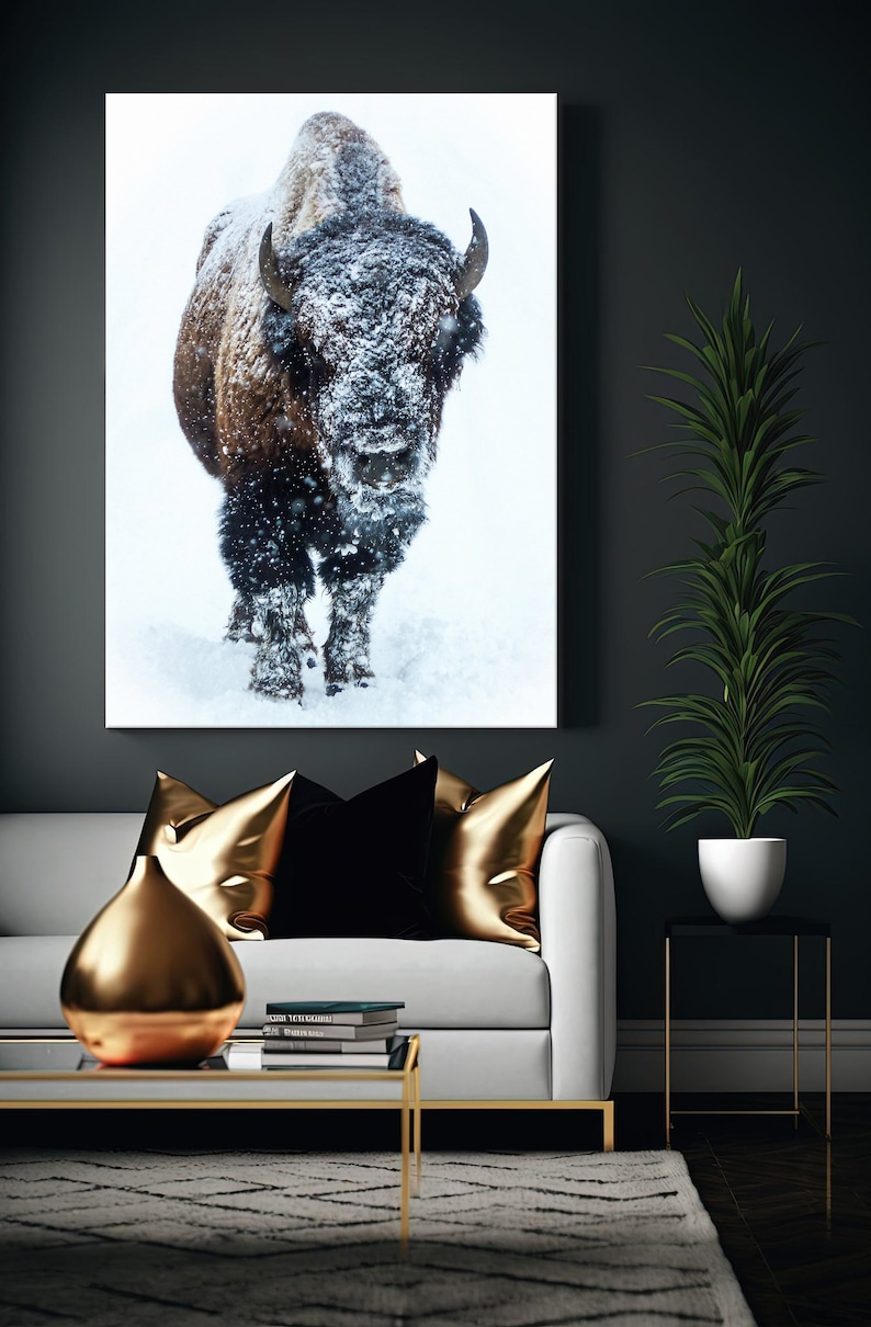 May include: A large, brown bison stands in a snowy field. The bison is covered in snow and the snow is falling around it.