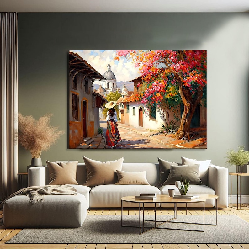 May include: A painting of a woman in a red dress and a straw hat walking down a cobblestone street in a small town. The street is lined with colorful buildings and there are trees with pink flowers in bloom.