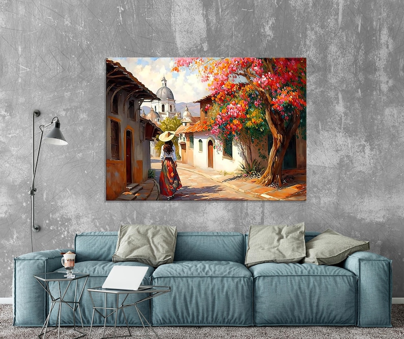 May include: A painting of a woman walking down a cobblestone street in a small town. The street is lined with colorful buildings and there is a large tree with pink flowers in the background.