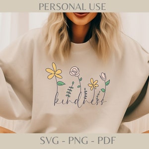 Könnte beinhalten: Ein beiges Sweatshirt mit einem Blumendesign und dem Wort "kindness" in Schreibschrift. Die Blumen sind gelb, rosa und weiß mit grünen Stielen. Der Text "PERSONAL USE" steht oben und "SVG - PNG - PDF" unten.