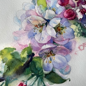 Close-up of pink watercolor apple flowers with delicate petals, green leaves, and soft blue background details.