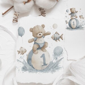 May include: Watercolor illustration of a teddy bear wearing a blue outfit, balancing on a ball with the number 1. The image includes blue balloons and fish, with water splashes, perfect for a baby's first birthday.
