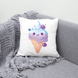 May include: A white pillow with a cute cartoon ice cream cone with blue and purple ice cream, a green leaf, and two purple cherries. The ice cream cone has a happy face and is smiling.