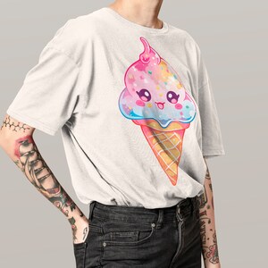 May include: A white t-shirt with a cartoon ice cream cone design. The ice cream is pink, blue, and white with sprinkles and a cherry on top. The ice cream cone has a happy face.