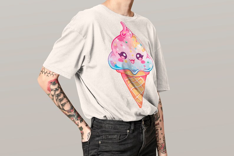 May include: A white t-shirt with a cartoon ice cream cone design. The ice cream is pink, blue, and white with sprinkles and a cherry on top. The ice cream cone has a happy face.