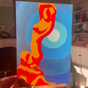May include: An abstract painting featuring a stylized human figure in shades of orange and red against a blue background. The figure is positioned in front of a series of concentric circles, creating a sense of depth and movement. The artwork is a vibrant display of color and form.