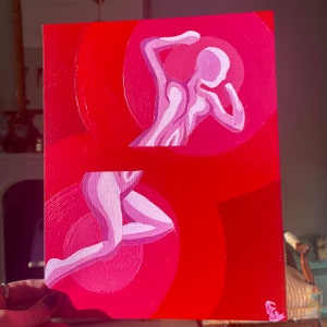 May include: An abstract painting on canvas featuring two stylized human figures in shades of pink against a vibrant red background. The figures are positioned within concentric circles, creating a sense of movement and depth. The artwork is signed in the lower right corner.