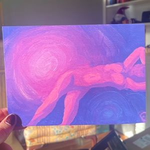 May include: An abstract painting featuring a reclining figure in shades of pink and orange against a swirling background of purple and blue. The artwork has a soft, dreamlike quality, with visible brushstrokes.