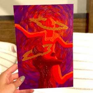 May include: Abstract painting with a figure in shades of red and orange, set against a swirling purple background. The figure has a gold halo and is depicted with broad brushstrokes. The artwork is held by a hand with glittery nail polish.