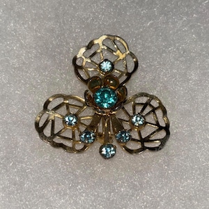 Vintage Gold tone brooch with blue rhinestones