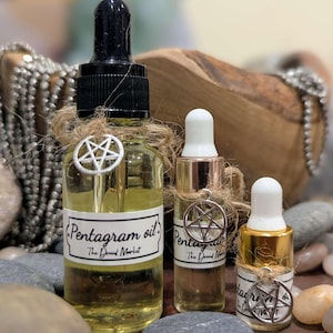 May include: Three glass bottles with droppers filled with a clear yellow liquid. Each bottle has a silver pentagram charm attached to a twine bow. The labels on the bottles read "Pentagram oil. The Druid Market."