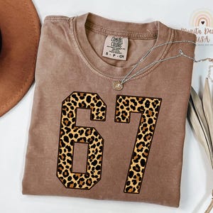 comfort colors expresso t-shirt with large leopard print 67 number design, folded viral meme top with animal print aesthetic