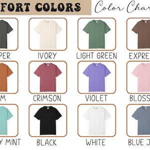 May include: Color chart showcasing Comfort Colors t-shirts in various hues. The image displays a grid of shirts in colors like pepper, ivory, light green, and expresso. Other colors include yam, crimson, violet, blossom, chalky mint, black, white, and blue jean.