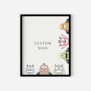 May include: A framed print with the text "CUSTOM SIGN" and five cartoon monsters in various colors, including green, pink, brown, and blue.