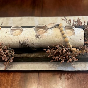 White birch candle holder, has three candle slots and comes with 3 glass tea light holders.