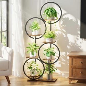 May include: A black metal plant stand with six circular frames and wooden shelves. The stand holds various potted green plants and flowers, creating a decorative display. The stand is placed near a window and a wooden cabinet.