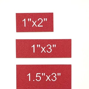 May include: Five red rectangular cards with white text indicating different sizes. The cards are arranged vertically from smallest to largest. The sizes are 1"x2", 1"x3", 1.5"x3", 2"x3", and 2"x4".