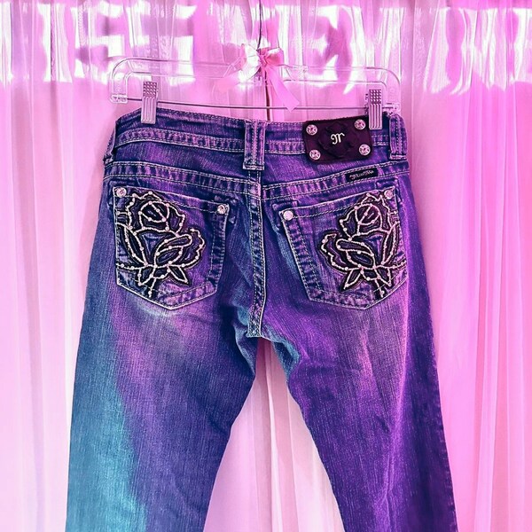 miss me 2000’s rose embellished medium wash jeans. stunning low-rise grunge styled piece with a bootcut fit