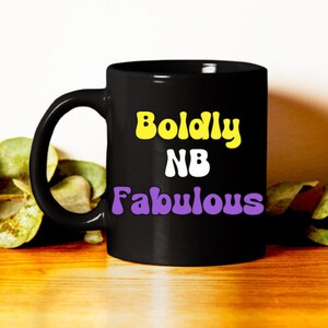 May include: Black coffee mug with the text "Boldly NB Fabulous" in yellow and purple letters.