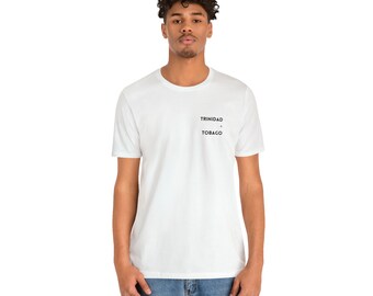 May include: White t-shirt with black text that reads "TRINIDAD & TOBAGO" on the chest.