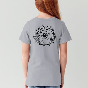 May include: A light gray t-shirt with a black and white illustration of a pufferfish on the back.