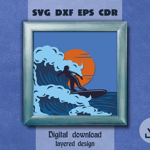 May include: A framed digital art print featuring a surfer riding a wave at sunset. The artwork is in shades of blue, orange, and black. Text at the top reads "SVG DXF EPS CDR" and at the bottom "Digital download layered design."