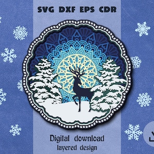 May include: A layered design featuring a deer standing in a snowy forest with a blue and green mandala background. The design is perfect for creating a winter-themed craft project.