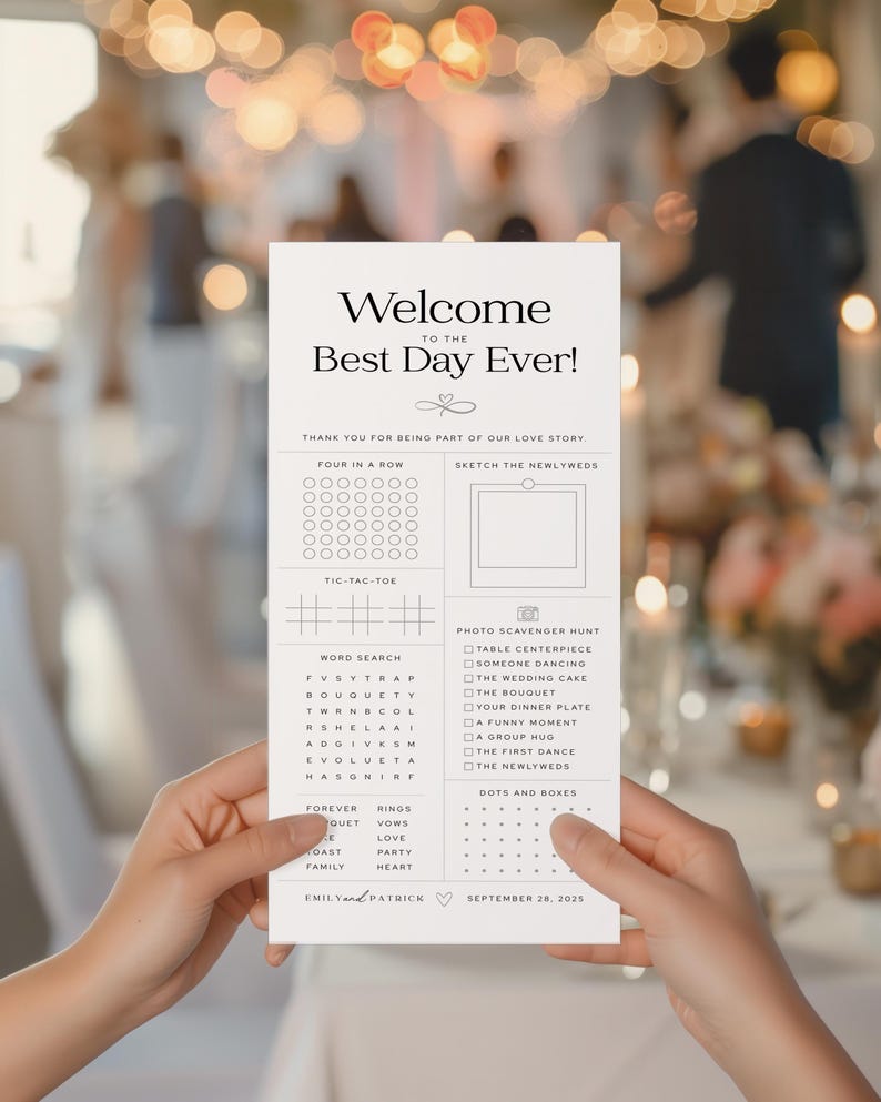 May include: A white wedding activity card held by hands, featuring the text "Welcome to the Best Day Ever!" and various games like Four in a Row, Tic-Tac-Toe, and a word search. The card includes a photo scavenger hunt and is dated September 28, 2025.