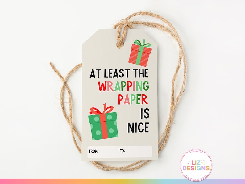 May include: A white gift tag with a red and green patterned gift box and the text "At least the wrapping paper is nice". The tag has blank spaces for "From:" and "To:".