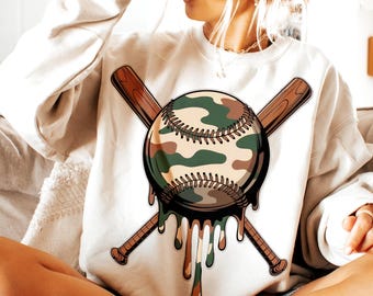 May include: A white sweatshirt with a graphic of a camouflage baseball with dripping paint and two crossed baseball bats.