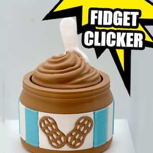 May include: A brown and white fidget clicker shaped like a peanut butter jar, with a swirl of brown on top and a white spoon. The jar has blue stripes and a peanut design. The text "FIDGET CLICKER" is in white.
