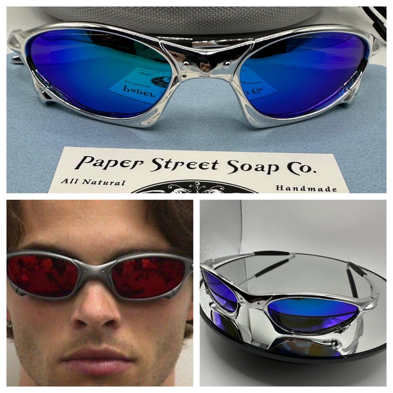 Op de afbeelding: Zilverkleurige zonnebril met blauwe spiegelglazen. De afbeelding toont ook een persoon die een vergelijkbare zonnebril met rode glazen draagt. Een kaart leest "Paper Street Soap Co. All Natural Handmade."