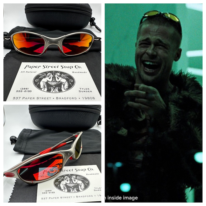 K&ouml;nnte beinhalten: Eine Sonnenbrille mit roten Spiegelgl&auml;sern, silbernem Gestell und roten Akzenten. Die Sonnenbrille befindet sich in einem schwarzen Etui mit einem schwarzen Beutel. Das Etui tr&auml;gt ein Etikett mit der Aufschrift "Paper Street Soap Co. All Natural Handmade Tyler Durden 537 Paper Street Bradford 19808".
