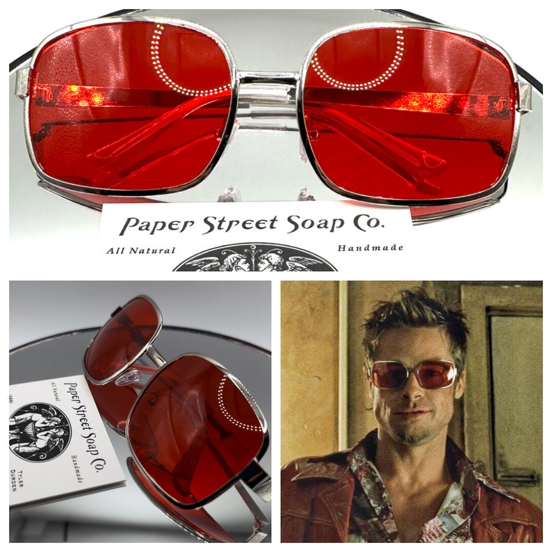 May include: Silver framed square sunglasses with red lenses. The sunglasses are shown on a white background and on a man's face. The text "Paper Street Soap Co. All Natural Handmade" is visible in the image.