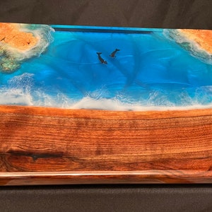 Very solid charcuterie board made from walnut, maple burl and food safe epoxy. 17 1/2” x 13 1/4” x 1 1/4”.