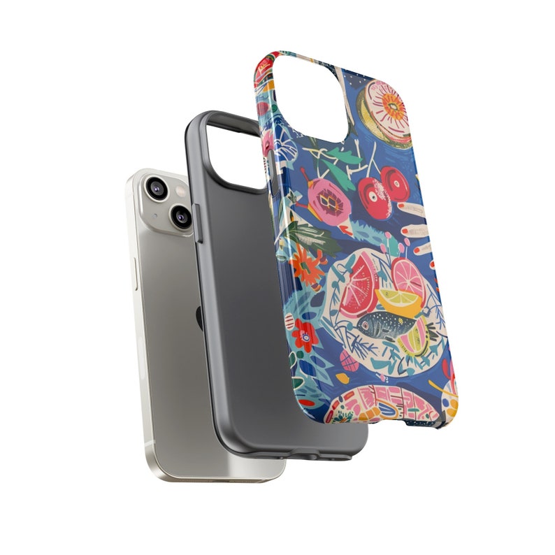 May include: A silver smartphone with a black case and a patterned phone case. The patterned case features a blue background with colorful illustrations of fruit, flowers, and a fish.