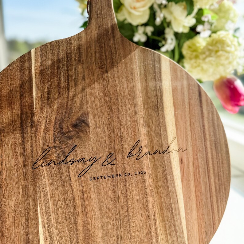 Personalized Cutting Board Custom Wedding Serving Board Acacia Wood Construction Large Cheese Board Beautiful Handle Design Anniversary Gift Special Engraved Names Wedding Date Detail Modern Kitchen Decor Elegant Display Piece