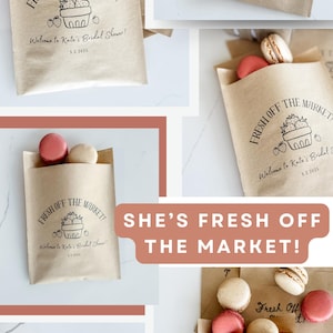 May include: Kraft paper bags with the text "Fresh Off The Market!" and a strawberry illustration. Some bags contain macarons and cookies. The bags are for a bridal shower, with the date 5.2.2025.