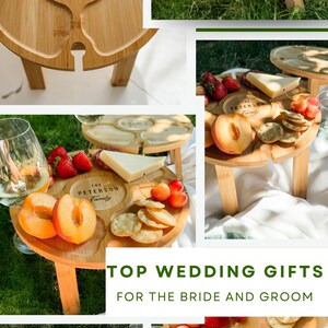 May include: Wooden picnic table with a personalized design, holding wine glasses, fruit, and cheese. The text "DESIGN YOURS HERE!" and "TOP WEDDING GIFTS FOR THE BRIDE AND GROOM" are visible. The table is designed to hold wine glasses.