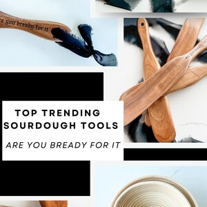 May include: Wooden sourdough bread tools, including spatulas and a bowl, are displayed on a white surface. The spatulas have the text "are you bready for it" and "The Life of a Doughgirl" engraved on them. The image also includes the text "Top Trending Sourdough Tools".