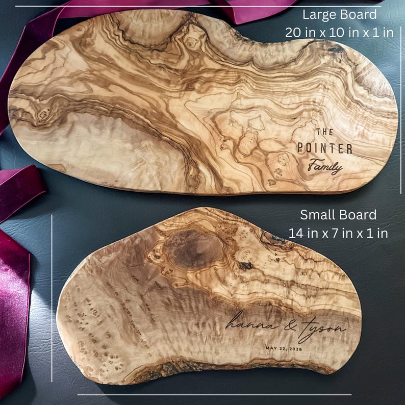 May include: Two wooden serving boards with natural wood grain patterns. The larger board is 20 inches long, 10 inches wide, and 1 inch thick, with "THE POINTER Family" engraved. The smaller board, 14 x 7 x 1 inches, is engraved with "hanna & tyson" and "MAY 22, 2026".