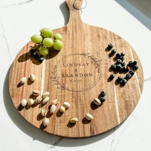 Personalized Cutting Board Custom Wedding Serving Board Engraved Cheese Board Acacia Wood Construction Large Serving Platter Beautiful Handle Detail Wedding Gift Wooden Board Personalized Kitchen Decor Modern Farmhouse Style Elegant Display