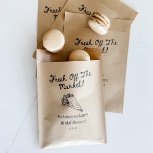 Party favors personalized cookie bags displayed on a dessert table with custom labels and bride’s name.