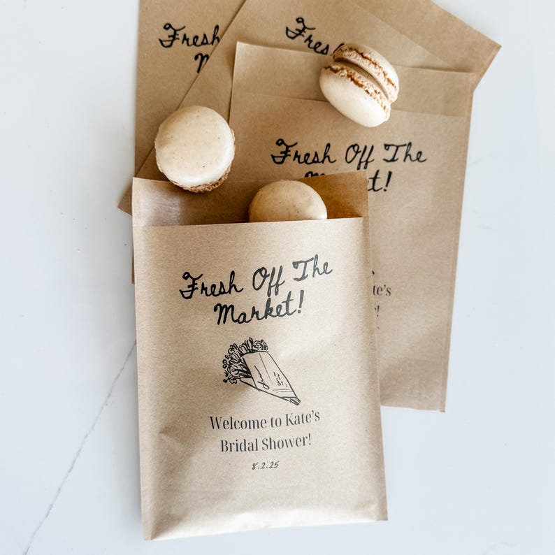 Party favors personalized cookie bags displayed on a dessert table with custom labels and bride’s name.